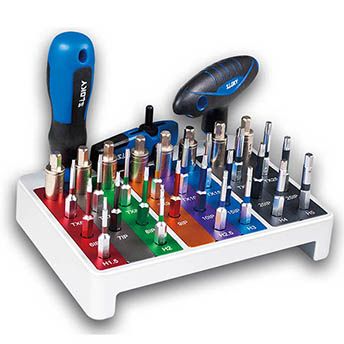 Color-coded screwdriver and bit set in a white stand, with two blue-handled screwdrivers leaning on the rack.